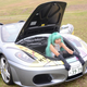 Illustration for article titled A Lady Dressed as Hatsune Miku. In a Ferrari Trunk